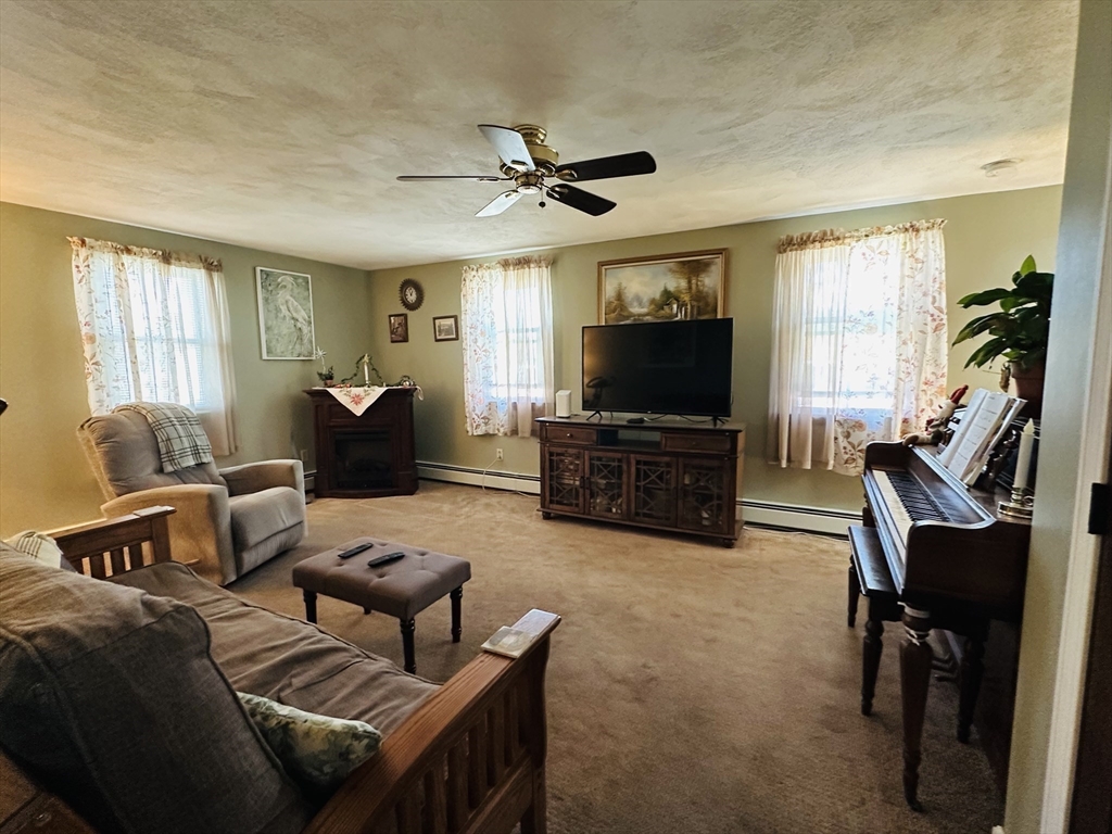 4 Mersea Street Saugus, MA 01906 - Photo 16 of 28 a living room with furniture a ceiling fan and a flat screen tv
