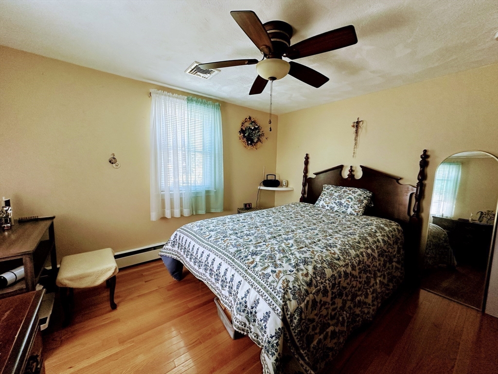 4 Mersea Street Saugus, MA 01906 - Photo 17 of 28 a bedroom with a bed and a chandelier