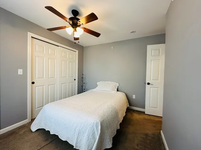 a bedroom with bed and window