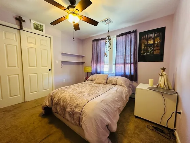 a bedroom with a bed dresser and a window