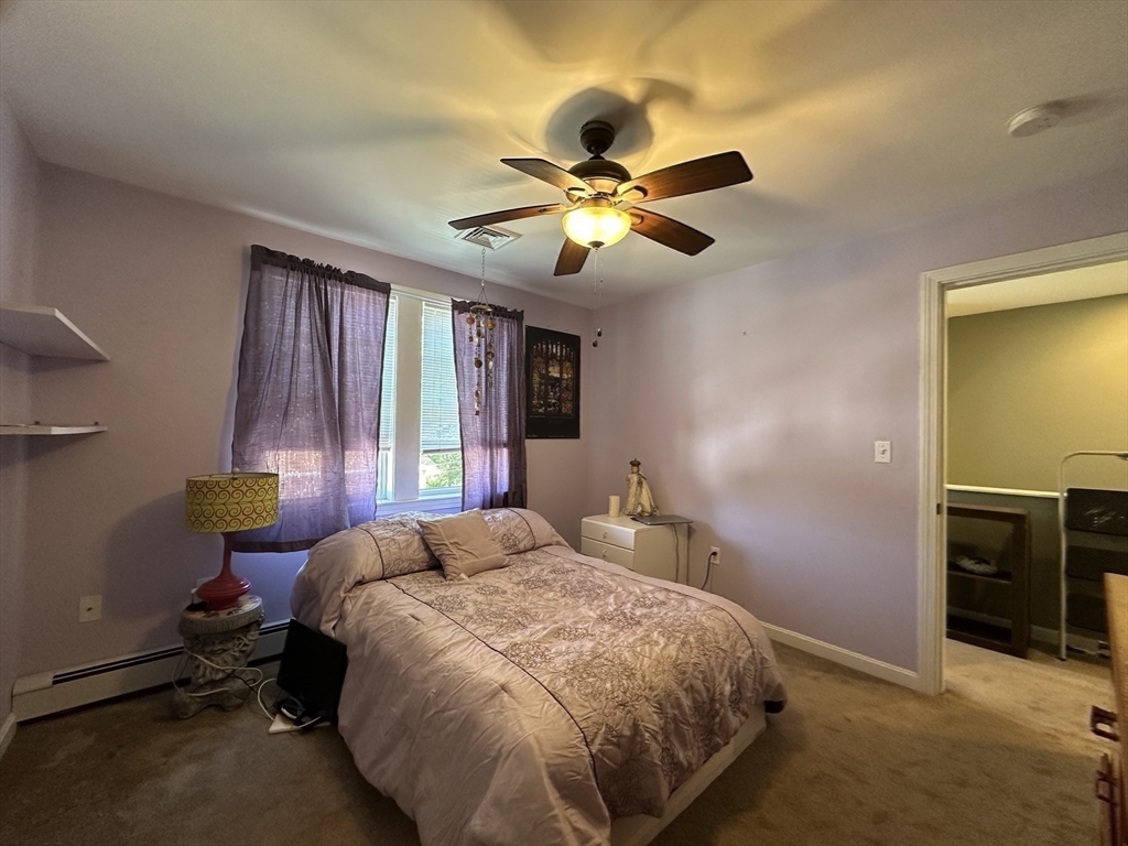 4 Mersea Street Saugus, MA 01906 - Photo 22 of 28 a bedroom with a bed and a chandelier