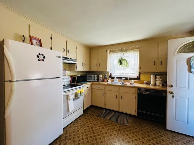 a kitchen with a refrigerator and a sink