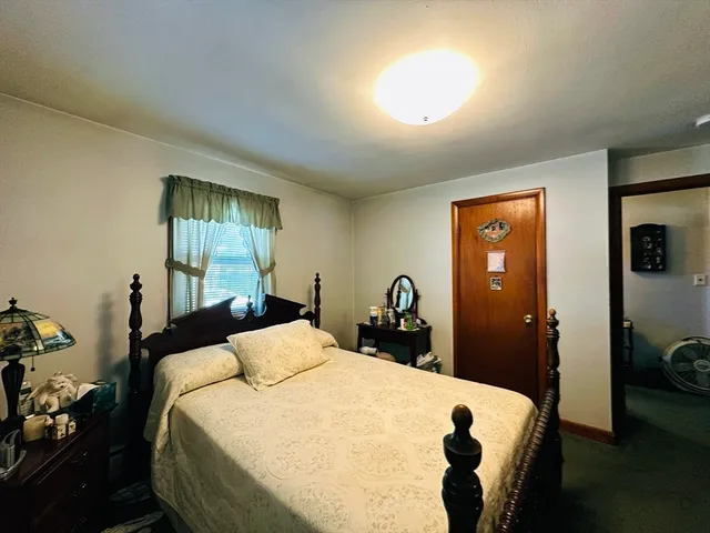 a bedroom with a bed and a mirror