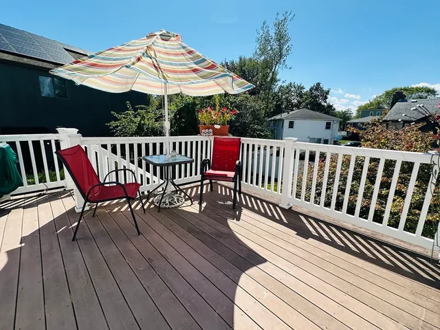 a view of a roof deck with a table and chairs