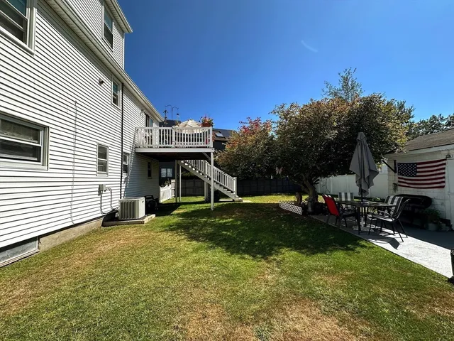 a view of a house with backyard and sitting area