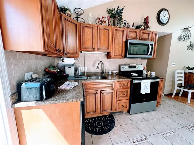 a kitchen with stainless steel appliances a stove a sink and a microwave