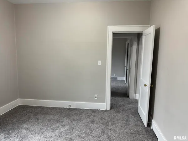 a view of an empty room with closet