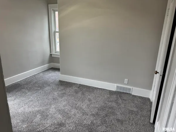 an empty room with a empty space and window