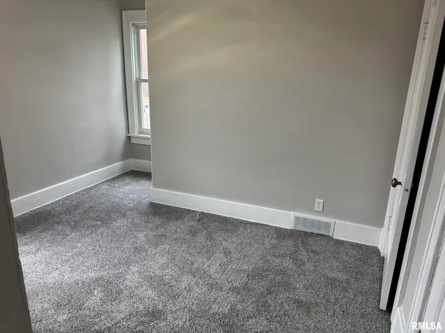 an empty room with a empty space and window