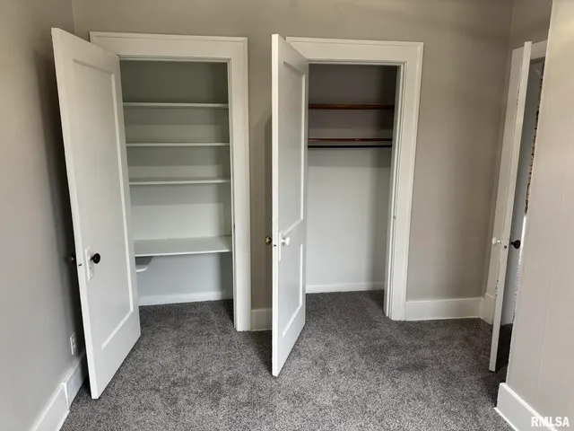 a view of an empty room with a closet
