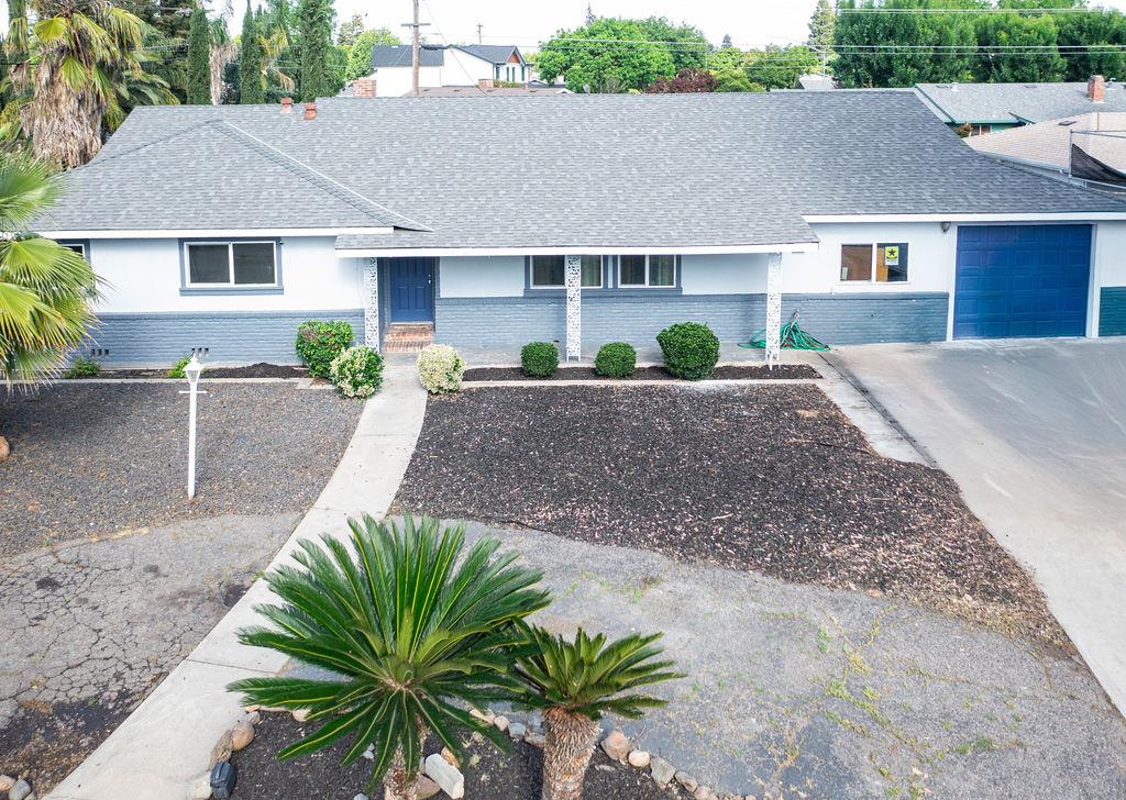 1124 Lakewood Avenue Modesto, CA 95355 - Photo 1 of 40 a house with a yard and a wooden fence
