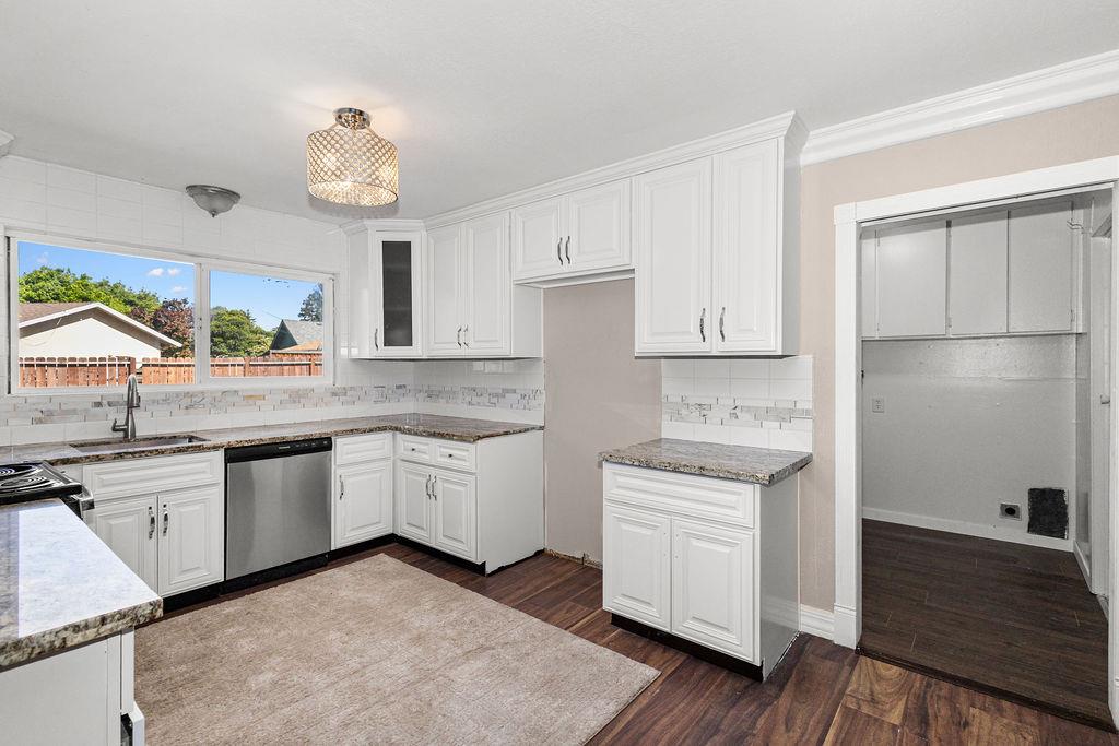1124 Lakewood Avenue Modesto, CA 95355 - Photo 19 of 40 a kitchen with granite countertop white cabinets and white appliances
