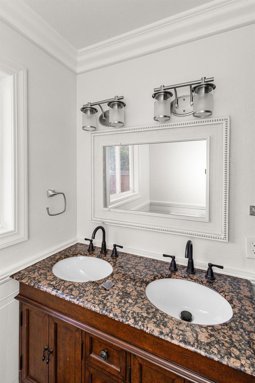 1124 Lakewood Avenue Modesto, CA 95355 - Photo 26 of 40 a bathroom with double vanity sinks and a mirror