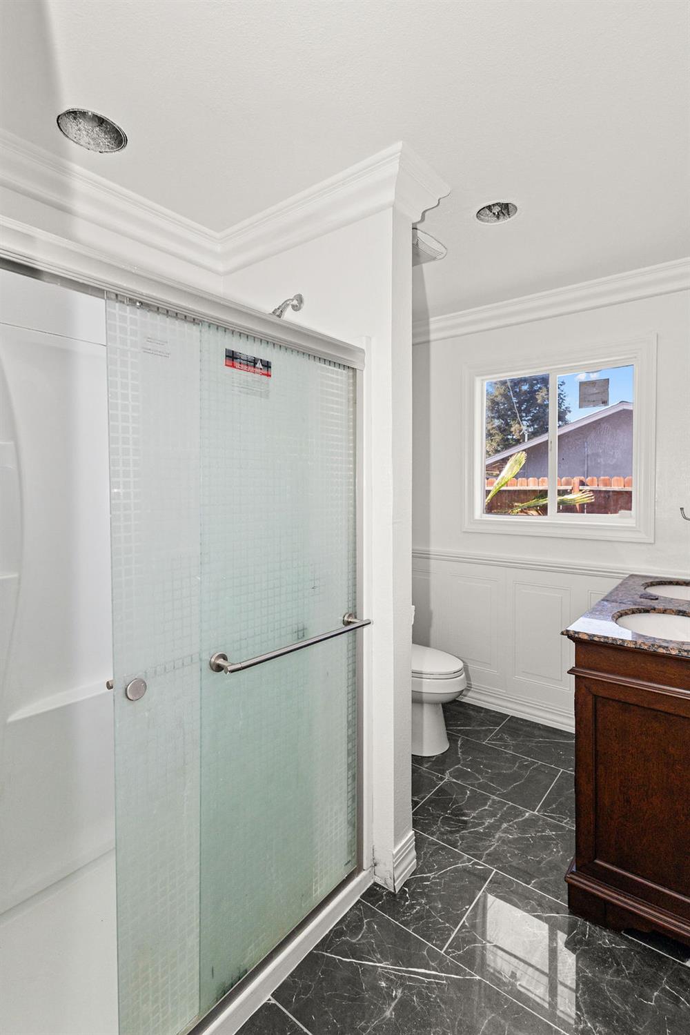 1124 Lakewood Avenue Modesto, CA 95355 - Photo 27 of 40 a bathroom with a granite countertop sink toilet and shower