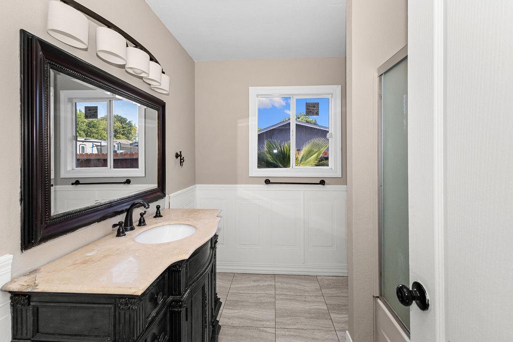 1124 Lakewood Avenue Modesto, CA 95355 - Photo 29 of 40 a bathroom with a sink vanity and a mirror