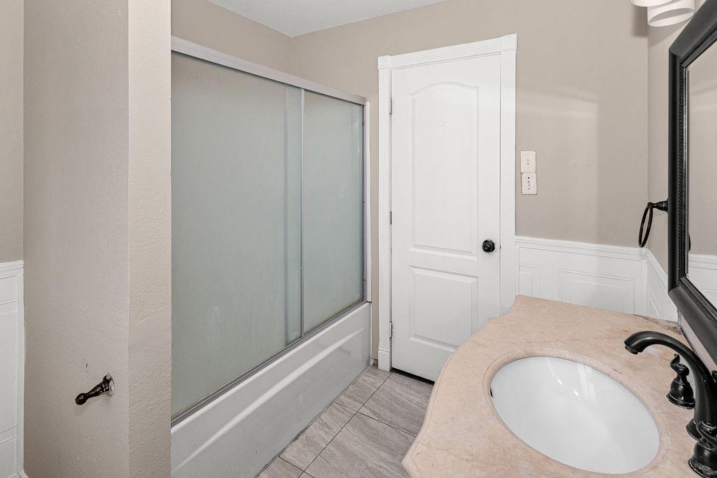1124 Lakewood Avenue Modesto, CA 95355 - Photo 30 of 40 a bathroom with a sink and a mirror