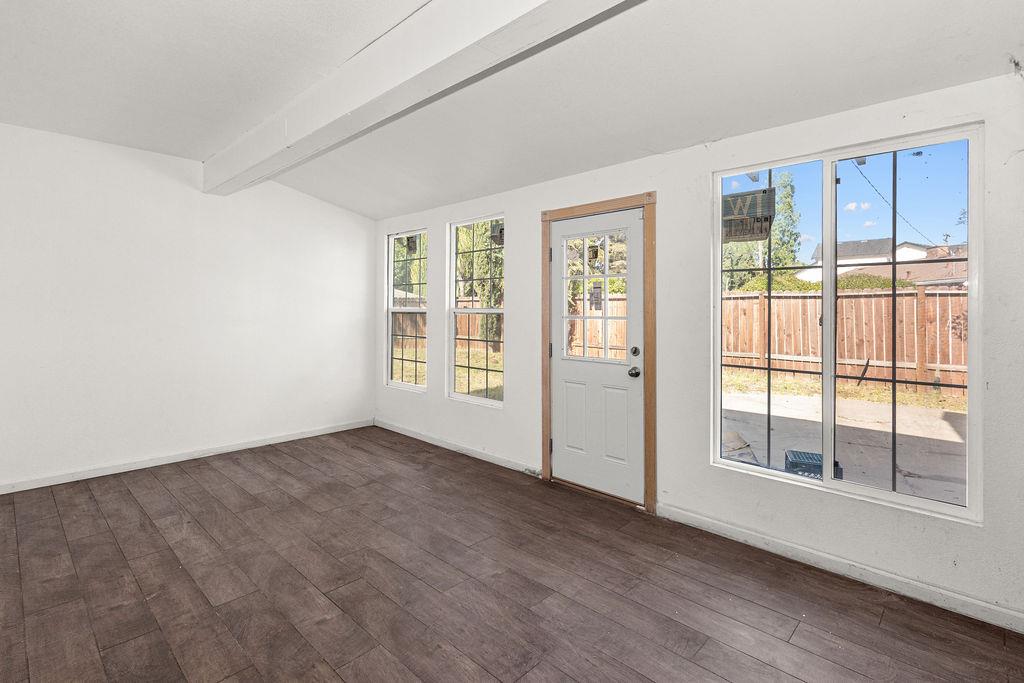 1124 Lakewood Avenue Modesto, CA 95355 - Photo 35 of 40 an empty room with wooden floor and windows