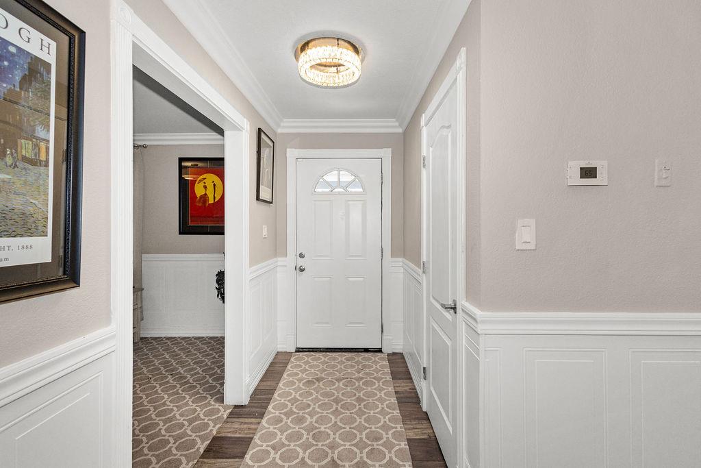 1124 Lakewood Avenue Modesto, CA 95355 - Photo 7 of 40 a view of a hallway with wooden floor and a door