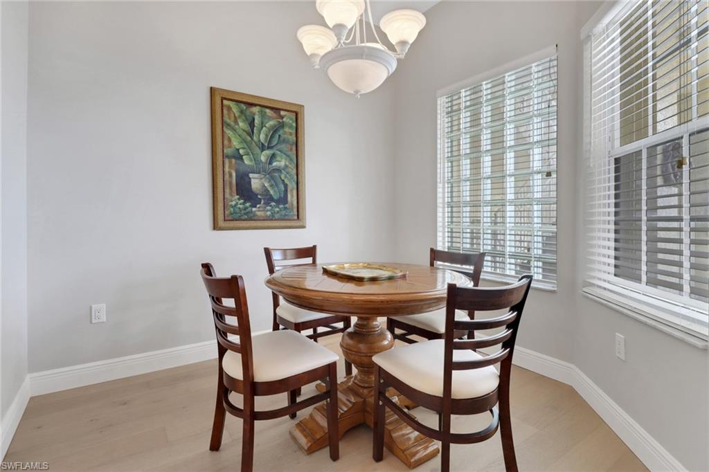 401 Bayfront Place, Unit 3502 Naples, FL 34102 - Photo 6 of 22 Dining area with a chandelier and light wood finished floors