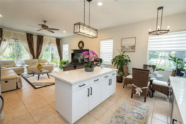 a kitchen with a sink a table and chairs in it