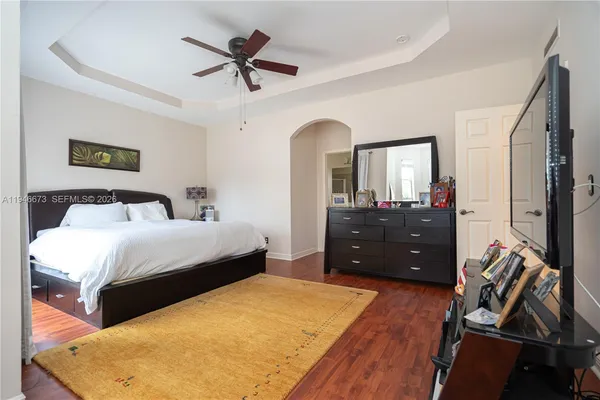 a spacious bedroom with a bed and a couch