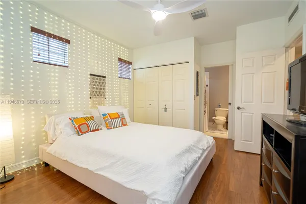 a view of a balcony with chairs and wooden floor