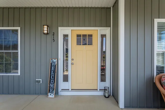 a room with painting and a potted plant