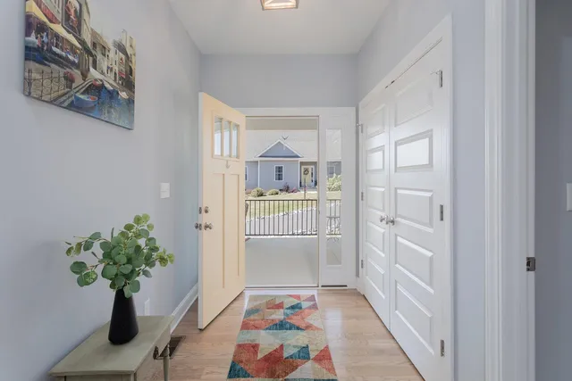 a view of room with hardwood floor and hallway