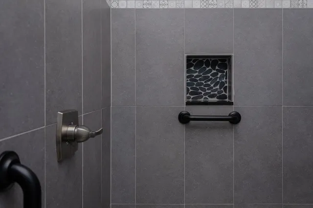 a bathroom with a granite countertop sink vanity mirror and toilet