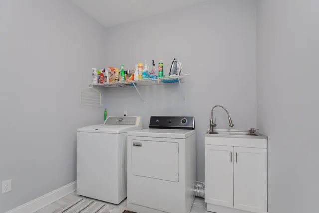 a front view of a house with a flower garden