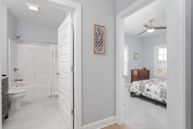 a front view of a house with a garden and yard