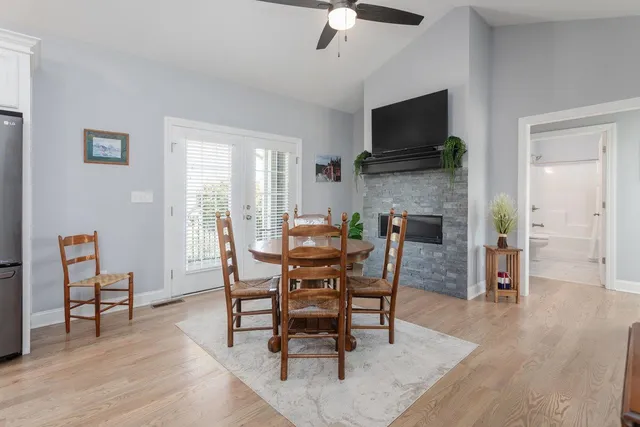 a kitchen with kitchen island a refrigerator stove a sink and a oven with wooden floor