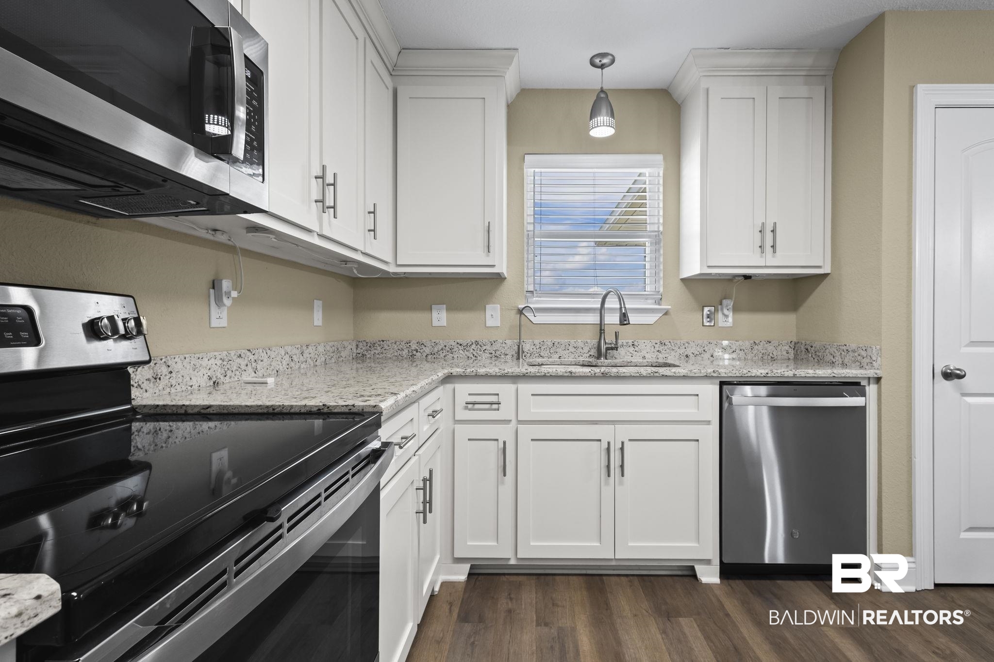 8781 Baptist Camp Road Elberta, AL 36530 - Photo 16 of 44 Kitchen with appliances with stainless steel finishes, dark wood-style flooring, white cabinets, and a sink