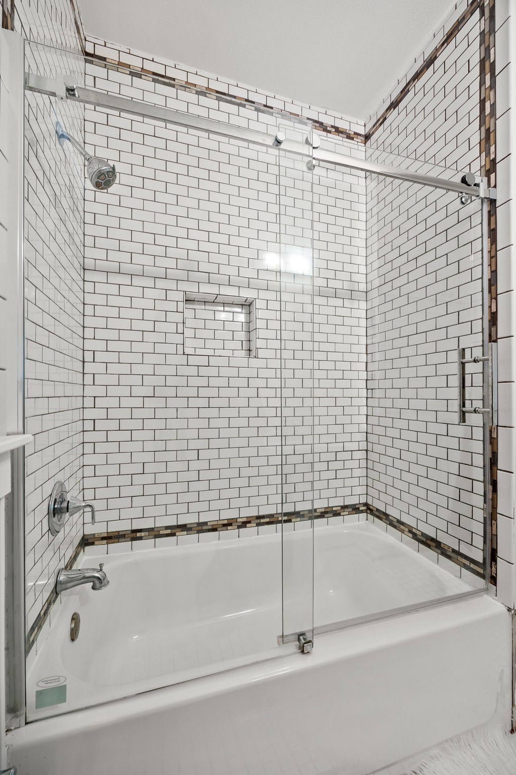 2503 Bryan Street Austin, TX 78702 - Photo 18 of 33 The shower-and-tub combo is wrapped in tile with a glass sliding door