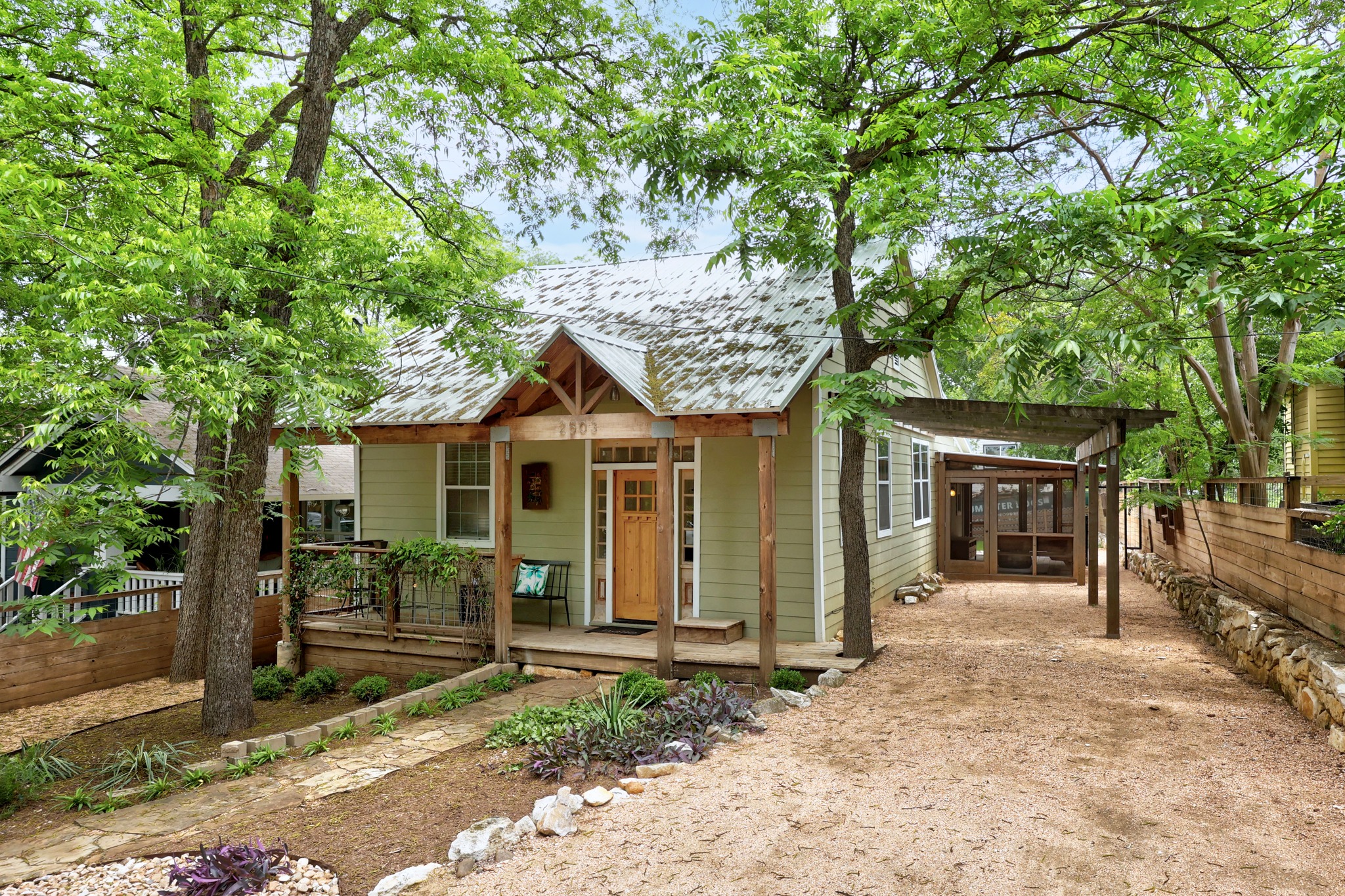 2503 Bryan Street Austin, TX 78702 - Photo 3 of 33 The gravel driveway pulls right into the side of the home, providing plenty of off-street parking while keeping the front view of the yard clear and open