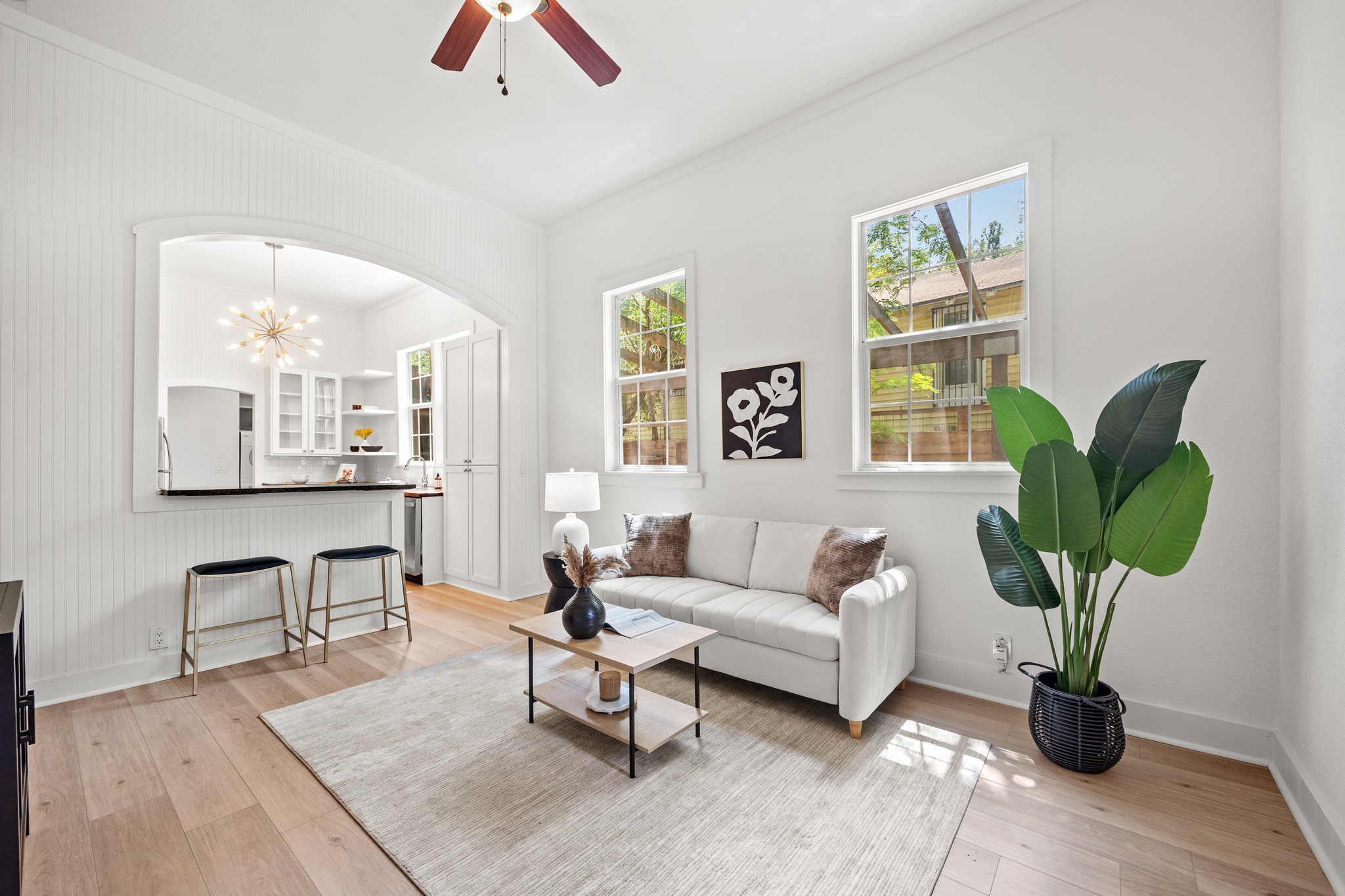 2503 Bryan Street Austin, TX 78702 - Photo 5 of 33 The living room feels immediately bright as you walk in, with wood flooring and neutral tones that reflect the natural light