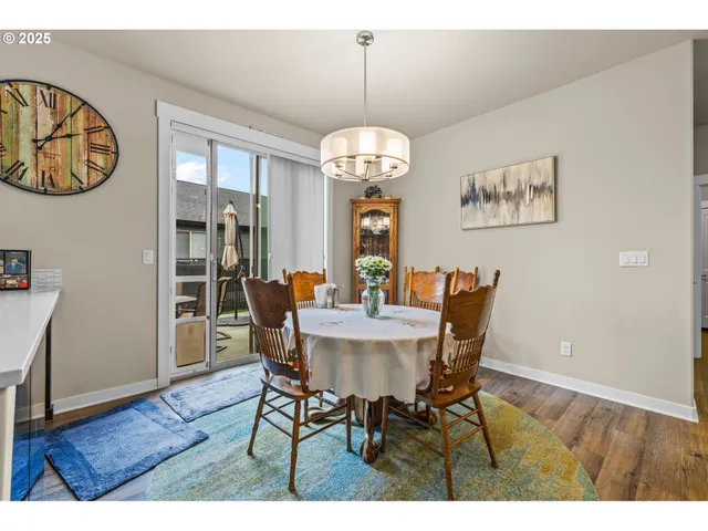 a view of a dining room with furniture wooden floor and a chandelier