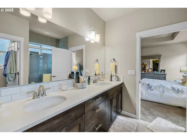 a en suite bathroom with a granite countertop sink and a mirror