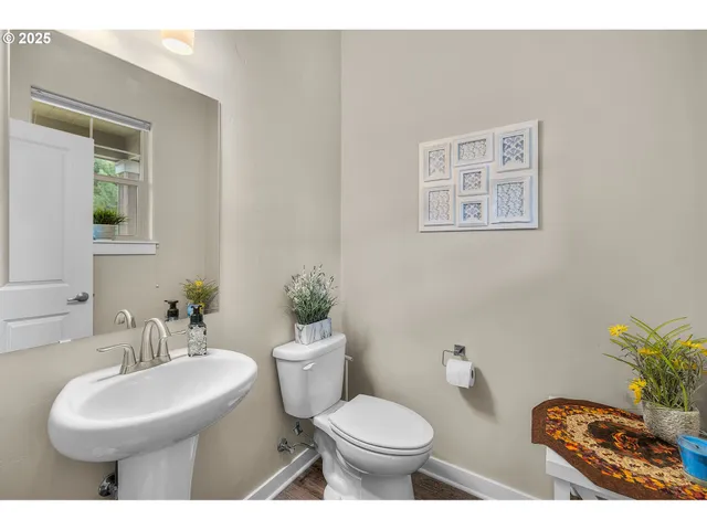 a bathroom with a toilet a sink and mirror