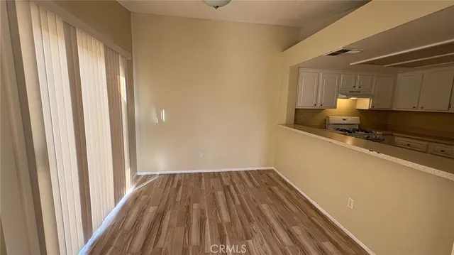 a view of a kitchen with wooden floor
