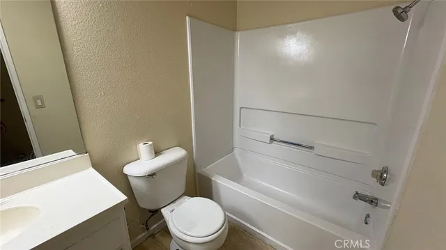 a white toilet sitting next to a bathroom sink