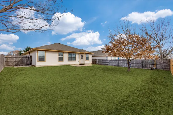 a front view of house with yard and trees