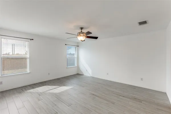 wooden floor in an empty room with a window