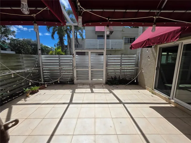 a view of a patio with a table and chairs