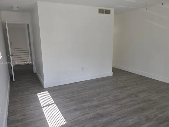 a view of wooden floor in an empty room