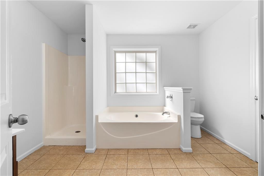80 Castle Court Ellijay, GA 30540 - Photo 20 of 31 a spacious bathroom with a bathtub and toilet
