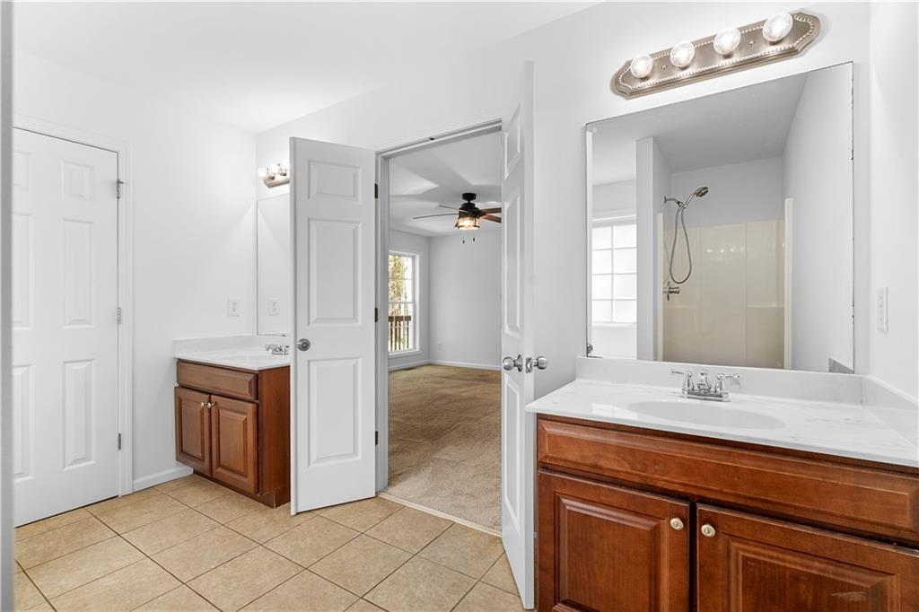 80 Castle Court Ellijay, GA 30540 - Photo 21 of 31 a bathroom with a granite countertop sink mirror and cabinets