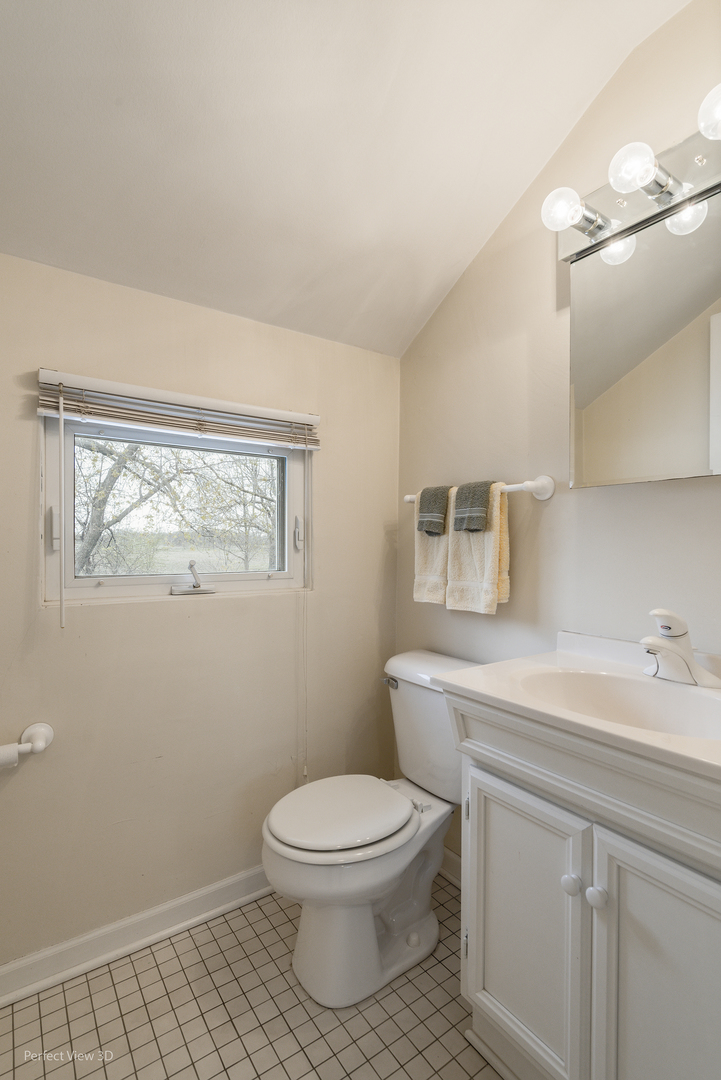 2580 Van Dyke Road Minooka, IL 60447 - Photo 21 of 32 a bathroom with a toilet a sink and mirror