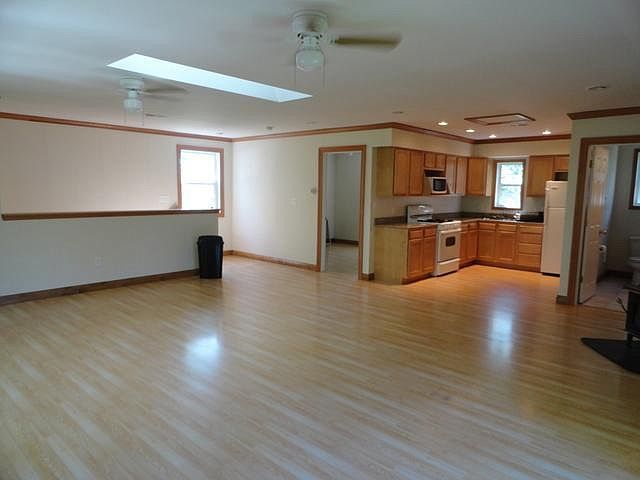 2580 Van Dyke Road Minooka, IL 60447 - Photo 23 of 32 a kitchen with stainless steel appliances wooden floor and large windows