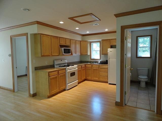 2580 Van Dyke Road Minooka, IL 60447 - Photo 24 of 32 a large kitchen with a sink stainless steel appliances and cabinets